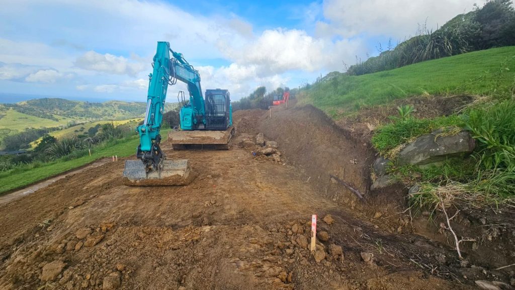 BTS Earthworks excavator cutting and benching a hillside building site in Auckland
